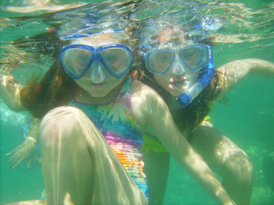 Two kids snorkeling underwater
